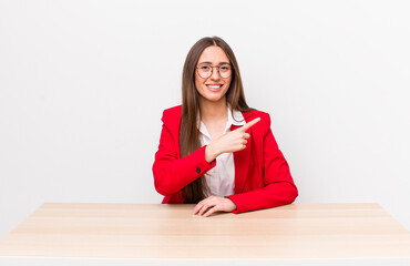 Poster - hispanic pretty woman smiling cheerfully, feeling happy and pointing to the side. business concept