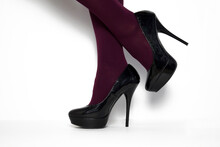 Black Stilettos With High Heels And Purple Stockings.
