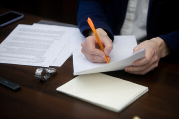 Wall Mural - Businessman signing a document after reading the agreement in office