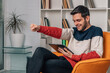 © carballo - young man with digital tablet or laptop at home excited celebrating success
