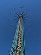 Low angle view of turning drop tower in famous amusement park Wurstelprater in Vienna, capital of Austria on sunny day in spring season.