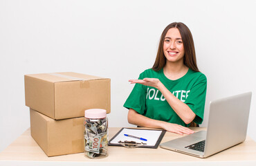 Poster - hispanic pretty woman smiling cheerfully, feeling happy and showing a concept. donations volunteer