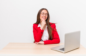 Poster - hispanic pretty woman smiling with a happy, confident expression with hand on chin.  business and desk concept