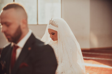 Muslim bride and groom praying at the mosque during a wedding ceremony. Selective focus