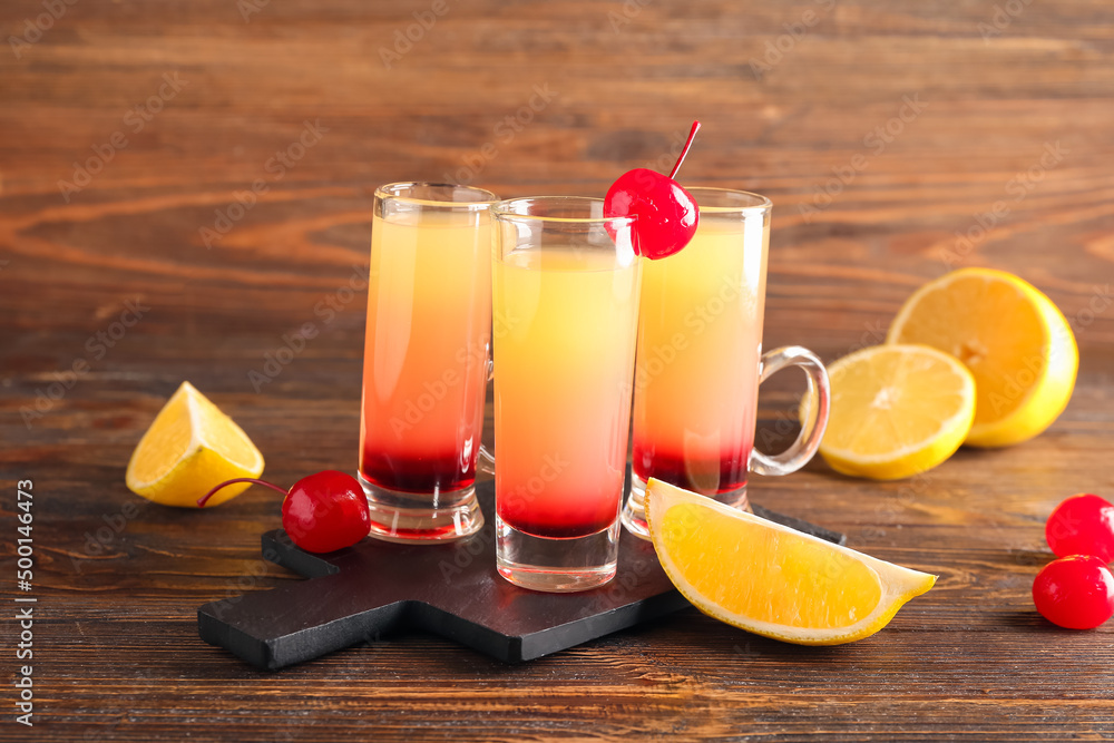 Board with tasty Pineapple Upside Down Cake Shots on wooden background