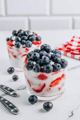 Poster - Two glasses of yogurt with berries. American patriotic breakfast. Selective focus.