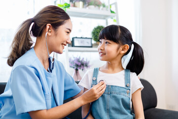 close up of happy girl and doctor on medical exam.ASian Female  doctor or nurse  Listening To Girls Chest With Stethoscope at home.