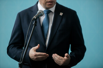 Wall Mural - Press conference with media microphones held in front of business man, spokesman or politician