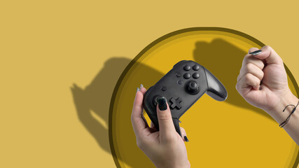 Video game console controller in gamer hand isolated on yellow background.