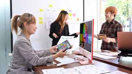 Wall Mural - creative team brainstorming, working together on mobile application software design project.
