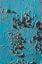 Blue Peeling Paint On The Wall. Old Concrete Wall With Cracked Flaking Paint. Weathered Rough Painted Surface With Patterns Of Cracks And Peeling. High Resolution Texture For Background And Design