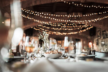 Beautiful Wedding Room With Wedding Table With Food, Flowers And Drinks, Decorations,lights Everywhere