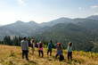 © New Africa - Group of tourists on hill in mountains. Drone photography