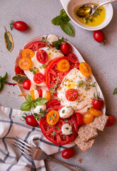 Caprese salad, tomatoes with mozzarella cheese and basil. Healthy vegetable meal