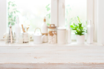 Wall Mural - wooden table over blurred kitchen window sill with food ingredients