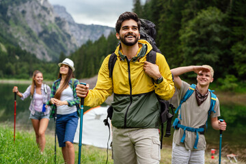 Wall Mural - group of happy friends with backpacks hiking together