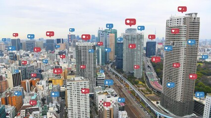 Aerial view of Tokyo cityscape with social media and notification icons pop up over the cities. Social media and Technology concept.