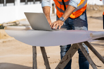 Poster - Team engineer and architects are meeting to plan for new project measuring layout of building blueprints in construction site,Construction residential new house in progress at building site.