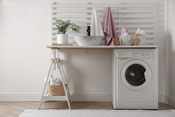 Canvas Print - Laundry room interior with modern washing machine and stylish vessel sink on white wooden countertop