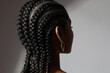 © face_reader_img - Close-up of African young woman with long braids posing on white background.