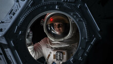 Portrait Of Caucasian Female Astronaut Flying Towards Spaceship Cupola Window. Space Exploration, Mars Mission