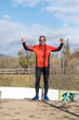 © 2Design - One senior runner man standing with arms raised after running