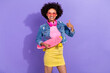 © deagreez - Photo of funky confident young lady dressed denim jacket earphones long board thumb up isolated purple color background