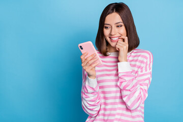 Wall Mural - photo of cute young brunette lady look telephone wear striped pullover isolated on blue background