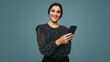 © Jacob Lund - Carefree young woman holding a smartphone in a studio