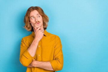 Sticker - Portrait of attractive hesitant doubtful long-haired guy making decision copy space isolated over bright blue color background