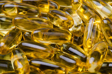 Close up of  oil filled capsules suitable for: fish oil, omega 3, omega 6, omega 9,  vitamin A, vitamin D, vitamin D3, vitamin E - Image