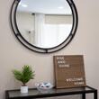 © Joni Hofmann - Welcome home sign on entry table with mints, plant and round mirror