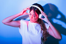 Woman Listening To Music In Studio With Lights