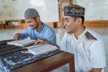 portrait of asian Man muslim learing to reading quran together during ramadan at the mosque with teacher