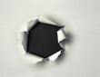 © by-studio - Loch in einem Papierblatt mit weissem Hintergrund