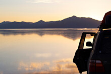 Spectacular Sunset At Uyuni Salt Lake, Bolivia. Offroad Car In Salar De Uyuni Salt Lake, Bolivia