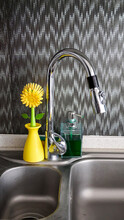 Flower Shaped Sink Brush Is Near Of The Kitchen Sink