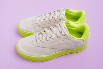 Wall Mural - beige neon-soled sneakers on color background - Image