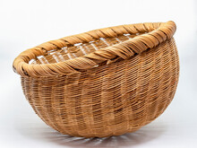 Studio Shot Of A Used Straw Basket On A Neutral Background