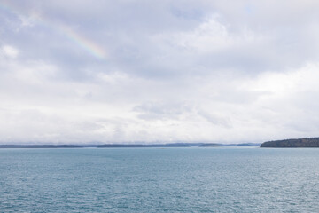 Wall Mural - Storm clouds over the ocean and island