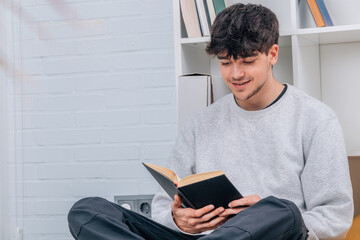 Poster - student or young man reading a textbook at home