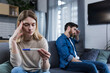 © Liubomir - Sad man and woman sitting on the couch, disappointed with a negative pregnancy test