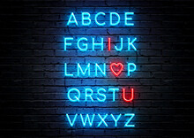 Blue And Red Neon Sign Loves Quote With Brick Wall Background; Alphabet Letters And I Love U.