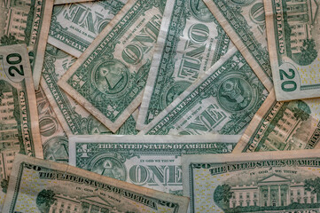 Background of american currency in one and twenty dollar denominations.