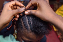 Hands Of An African Nigerian Hair Dresser Or Stylist Making Weaving Hairstyle For A Client In Saloon