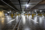 Fototapeta  - View of the underground parking, a lot of free places, in a shopping complex