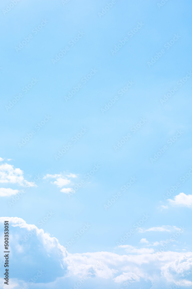 Soft fluffy cumulus clouds above the light blue sky in sunny day ...