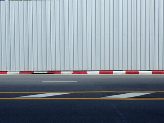 Canvas Print - metal sheet of fence in street with asphalt road