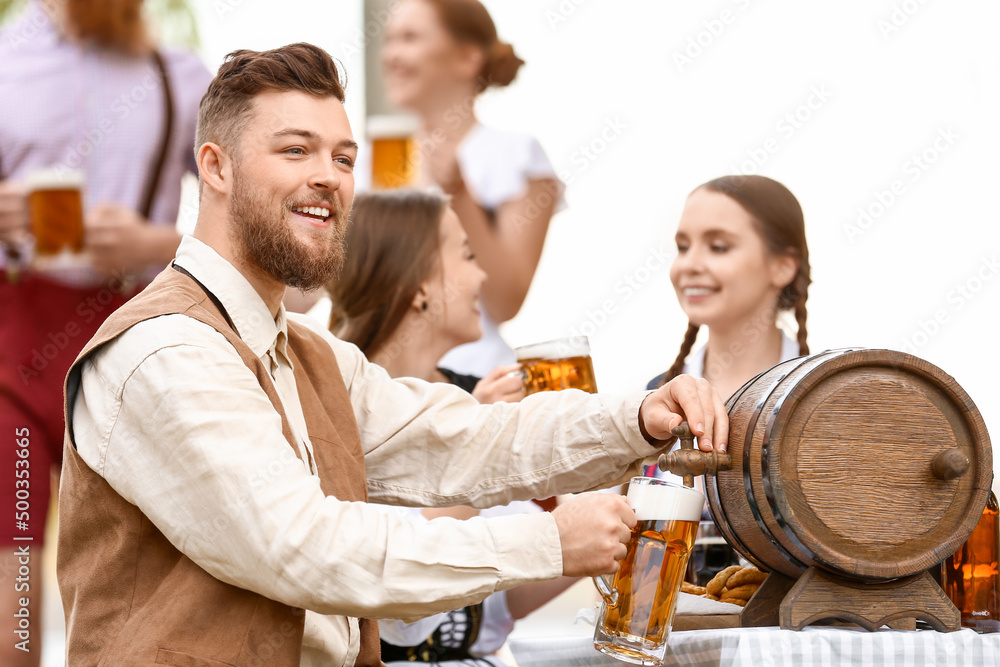 Man with beer celebrating Octoberfest outdoors