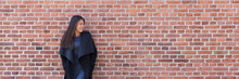 Asian Beauty Woman Fashion Model Wearing Autumn Coat Outside Looking Sideways On Brick Wall Background. Panoramic Banner Copy Space